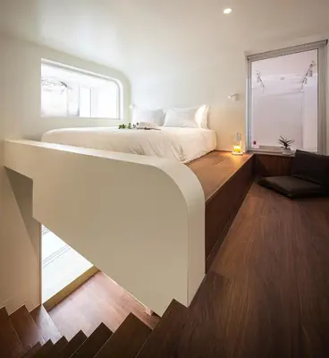 a bedroom with a large bed and a window at Bonsai Hotel Bangkok in Bangkok