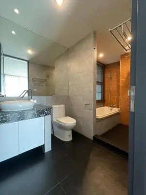 a bathroom with a sink and a toilet and a tub at ViVi Avenue Thonglor in Bangkok