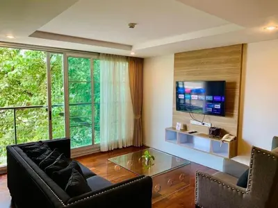 a living room with a couch and a tv at ViVi Avenue Thonglor in Bangkok