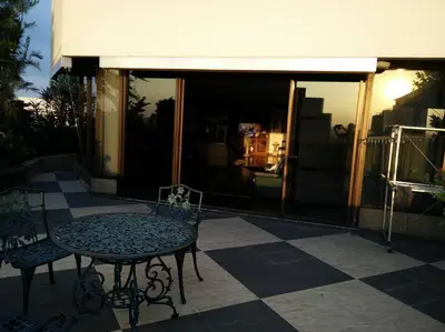 a patio with a table and chairs in front of a building at Stunning 24th Fl Terrace Penthouse! in Bangkok