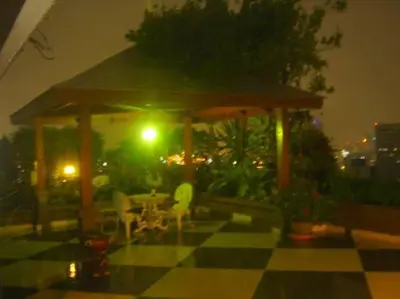 a gazebo with a table and chairs at night at Stunning 24th Fl Terrace Penthouse! in Bangkok