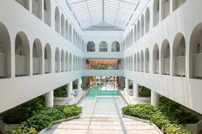 an internal view of a building with plants at Away Bangkok Riverside Kene in Bangkok