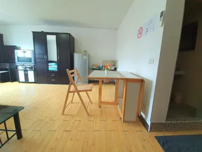 a kitchen with a table and a chair and a refrigerator at Great Location At IMPACT ARENA Muang Thong Thani C3 in Pak Kret