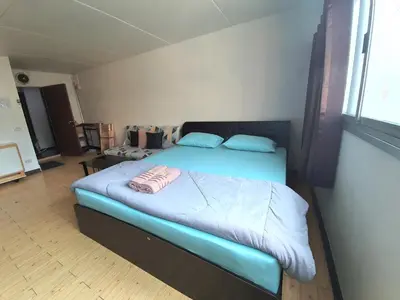 a bedroom with a large bed with blue sheets at Great Location At IMPACT ARENA Muang Thong Thani C3 in Pak Kret