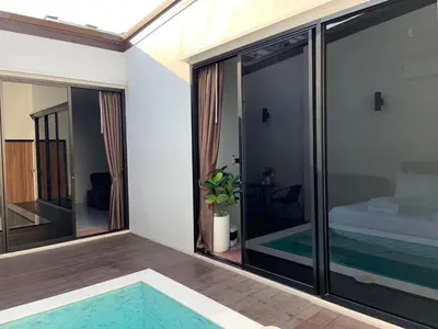 a view of a room with glass doors and a pool at VEVILLA in Bangkok