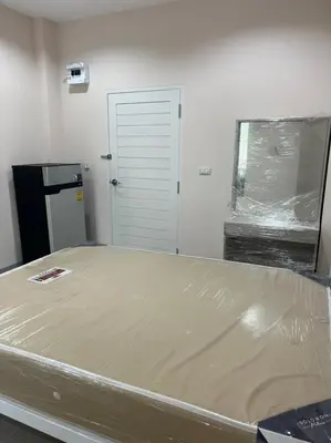 a bed is being constructed in a room at Firstbuild Apartment (เฟิร์สบิวท์อพาร์ทเม้น) in Bangkok