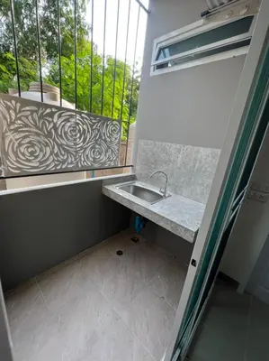 a small bathroom with a sink and a window at Firstbuild Apartment (เฟิร์สบิวท์อพาร์ทเม้น) in Bangkok