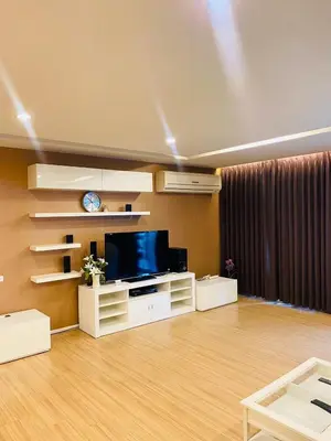 a living room with a flat screen tv on a wall at iCheck inn Residence Sukhumvit 1 in Bangkok
