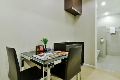 a desk with chairs and a table with magazines on it at iCheck inn Residence Sukhumvit 1 in Bangkok