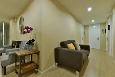 a living room with a couch and a table at iCheck inn Residence Sukhumvit 1 in Bangkok