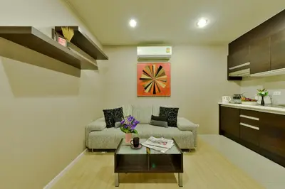 a living room with a couch and a table at iCheck inn Residence Sukhumvit 1 in Bangkok