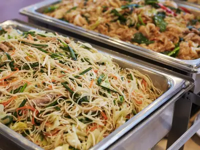 two trays of food on display at a buffet at Bangkok City Suite in Bangkok