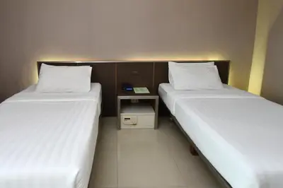 two beds sitting next to each other in a room at Bangkok City Suite in Bangkok