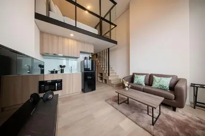 a living room with a couch and a table at Ramada By Wyndham Bangkok Sukhumvit 87 in Bangkok