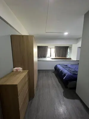 a small bedroom with a bed and a window at W71 in Bangkok