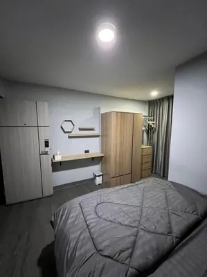 a bedroom with a large bed and a desk at W71 in Bangkok