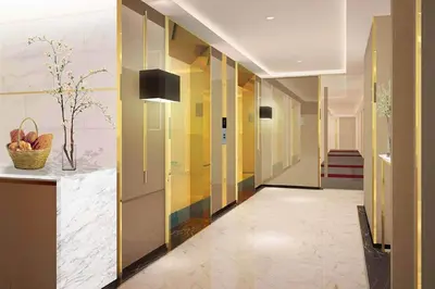 a hallway with colorful walls and a hallway with a basket of fruit at FX HOTEL NANA in Bangkok