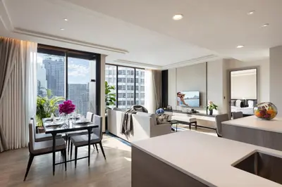 a living room with a kitchen and a dining room at Ascott Thonglor Bangkok in Bangkok