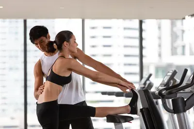 a man and woman exercising on a treadmill in a gym at Ascott Thonglor Bangkok in Bangkok