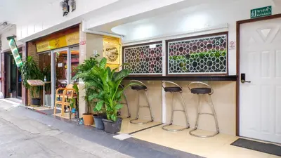 a store front with stools in front of a store at Usman Halal Home in Bangkok