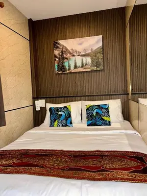 a bedroom with a large bed with two pillows at Usman Halal Home in Bangkok