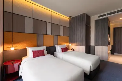 two beds in a hotel room with two beds sidx sidx sidx at Ramada Plaza by Wyndham Bangkok Sukhumvit 48 in Bangkok