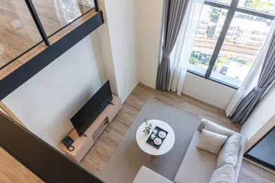 an overhead view of a living room with a couch and a tv at Ramada Plaza by Wyndham Bangkok Sukhumvit 48 in Bangkok