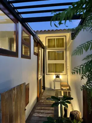 a porch of a house with a bench on it at Humz Canal Stay in Nonthaburi