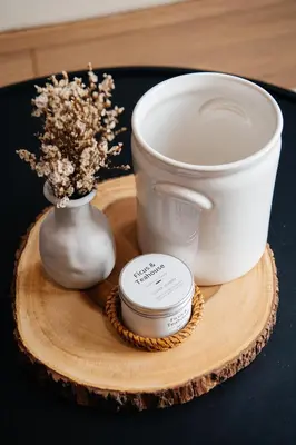 a wooden tray with a cup and a vase with flowers at VST Punnawithi in Bangkok