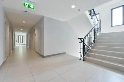 a hallway of a building with a staircase and a stair case at VST Punnawithi in Bangkok