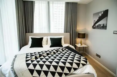 a bedroom with a bed with a black and white comforter at Sukhumvit 11#Luxury#Pool#Gym#BTS Nana&MRT Sukhumvit#1BR#Max2ppl in Bangkok