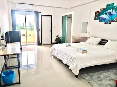 a large white bedroom with a bed and a desk at MY HOME Hotel - Phutthamonthon 4 Road, near Mahidol University Salaya in Ban Krathum Lom