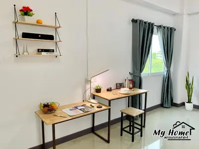a desk in a room with a window at MY HOME Hotel - Phutthamonthon 4 Road, near Mahidol University Salaya in Ban Krathum Lom