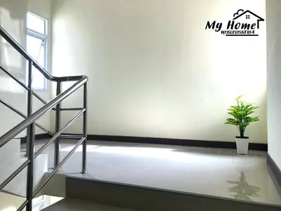 a staircase in a room with a potted plant at MY HOME Hotel - Phutthamonthon 4 Road, near Mahidol University Salaya in Ban Krathum Lom