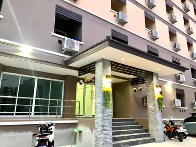 a house with a green door and a building at MY HOME Hotel - Phutthamonthon 4 Road, near Mahidol University Salaya in Ban Krathum Lom