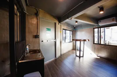 an empty room with a sink and a door at Episode 11 Hostel Sukhumvit in Bangkok
