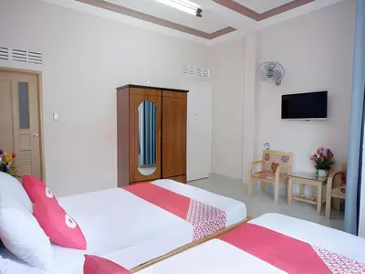 a bedroom with two beds and a tv on the wall at Episode 11 Hostel Sukhumvit in Bangkok