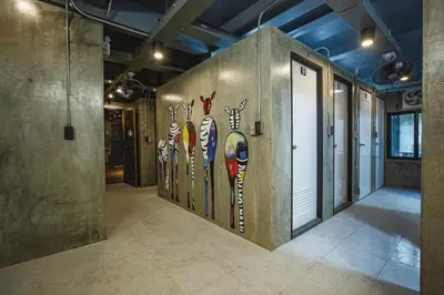 a room with a wall with paintings of birds on it at Episode 11 Hostel Sukhumvit in Bangkok