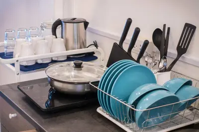 a kitchen counter with dishes in a dish rack at T4 Two Bedrooms Full kitchen/1 min to BTS in Bangkok