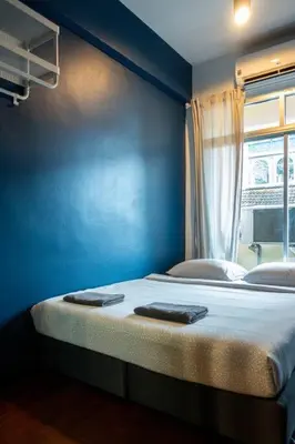 a blue room with a bed with two towels on it at T4 Two Bedrooms Full kitchen/1 min to BTS in Bangkok