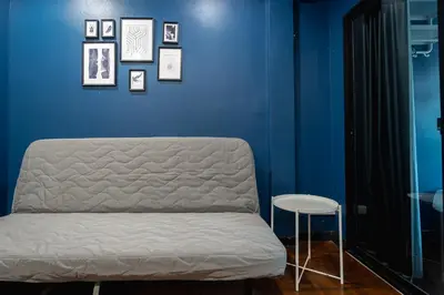 a blue room with a bed and a stool at T4 Two Bedrooms Full kitchen/1 min to BTS in Bangkok