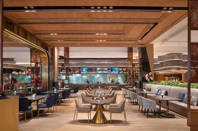 a rendering of a restaurant with tables and chairs at Asawin Grand Convention Hotel in Bangkok