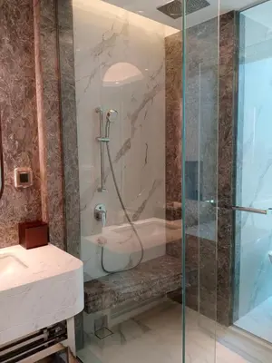 a bathroom with a shower and a sink at Asawin Grand Convention Hotel in Bangkok