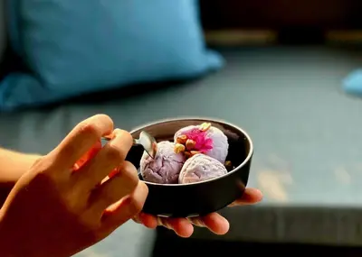 a person is holding a bowl of ice cream at Coconut Lane Bangkok in Bangkok