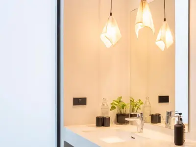a bathroom with a sink and a mirror at Coconut Lane Bangkok in Bangkok