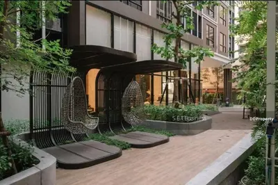 a black bench in front of a building at SHADE of Sky Sathon - Pool, Fitness, Parking, Wifi in Bangkok