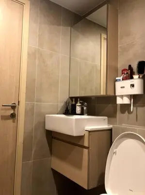 a bathroom with a sink and a toilet at SHADE of Sky Sathon - Pool, Fitness, Parking, Wifi in Bangkok