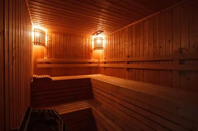 a wooden sauna with lights on the inside of it at Harmony Living Condominium in Makkasan