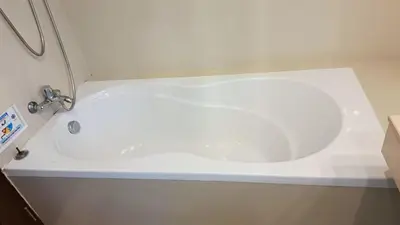 a white bath tub with a sink in a bathroom at Harmony Living Condominium in Makkasan