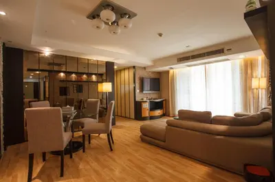 a living room with a couch and a dining room at Harmony Living Condominium in Makkasan